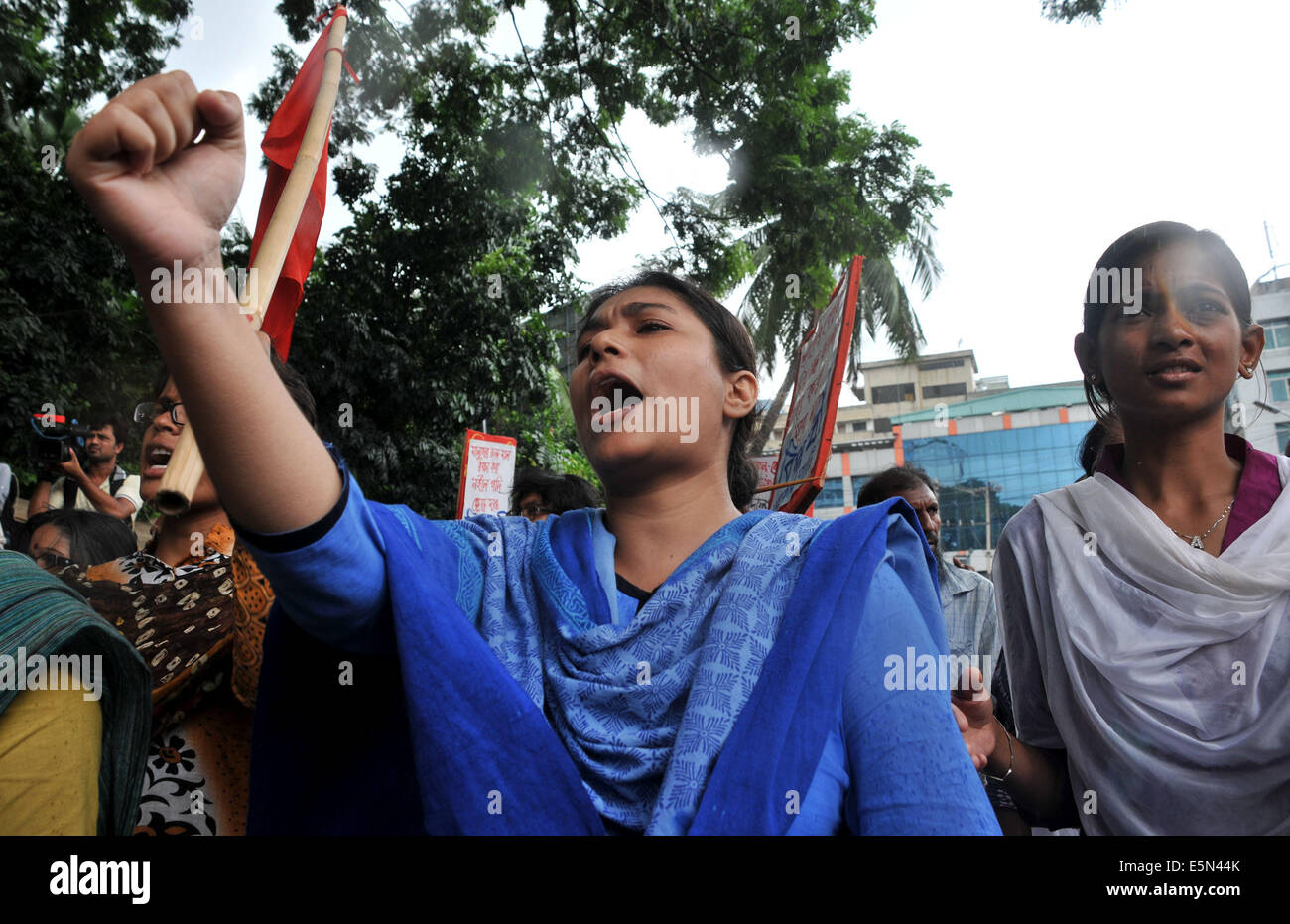 Dhaka, Bangladesh. 4th Aug, 2014. An activist of left-wing political party shouts slogans during a protest rally against unpaid salaries in front of Press Club in Dhaka, Bangladesh, Aug. 4, 2014. Several hundreds of workers demonstrated Monday demanding three months unpaid salaries and Eid Bonus. Credit:  Shariful Islam/Xinhua/Alamy Live News Stock Photo