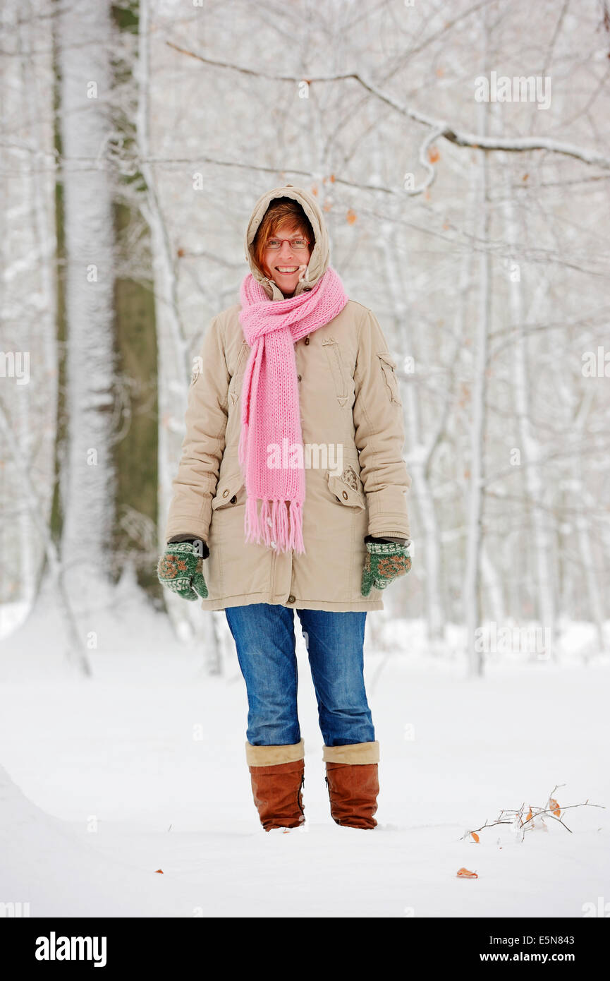 Woman in European Beech forest (Fagus sylvatica) in winter, North Rhine-Westphalia, Germany Stock Photo