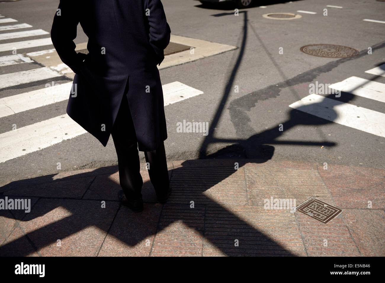 man in black at crosswalk usa Stock Photo