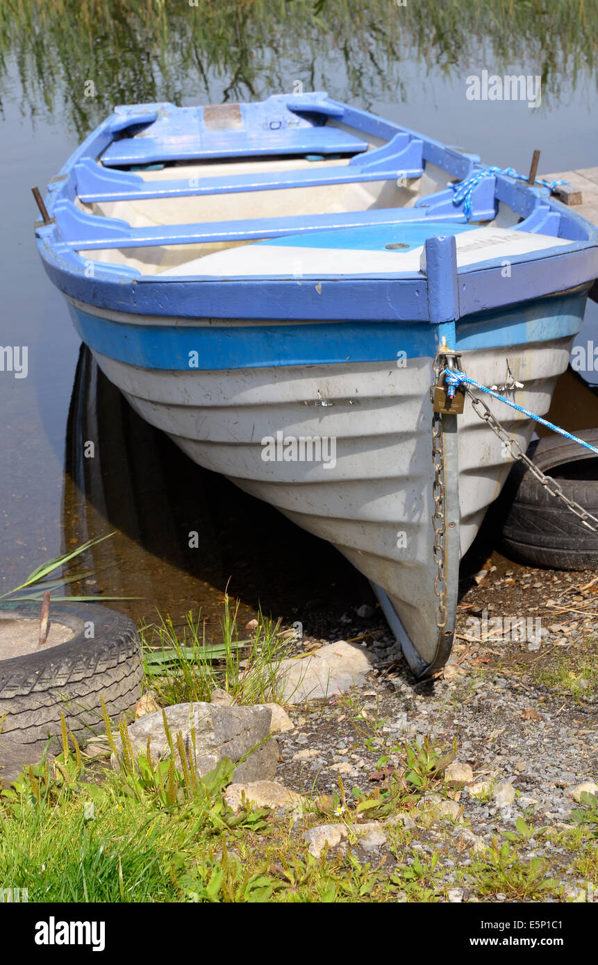 Blue and white rowing boat for hire at Lisloughery Pier,Cong on the shores of Lough Corrib, Ireland. Stock Photo