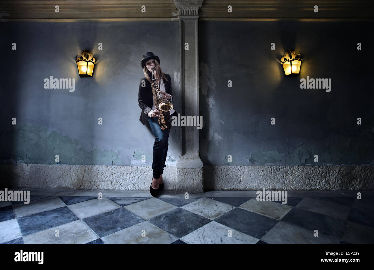 young beautiful woman in black hat with saxophone Stock Photo Alamy