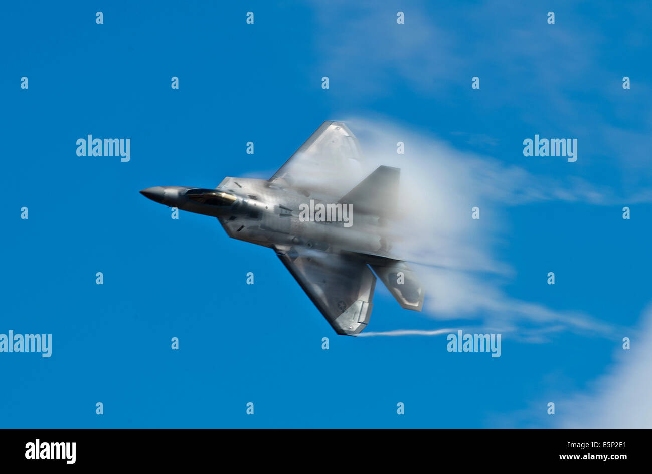 A US Air Force F-22 Raptor stealth fighter aircraft performs aerial maneuvers over Joint Base Elmendorf-Richardson during the Arctic Thunder Open House July 26, 2014 in Anchorage, Alaska. Stock Photo