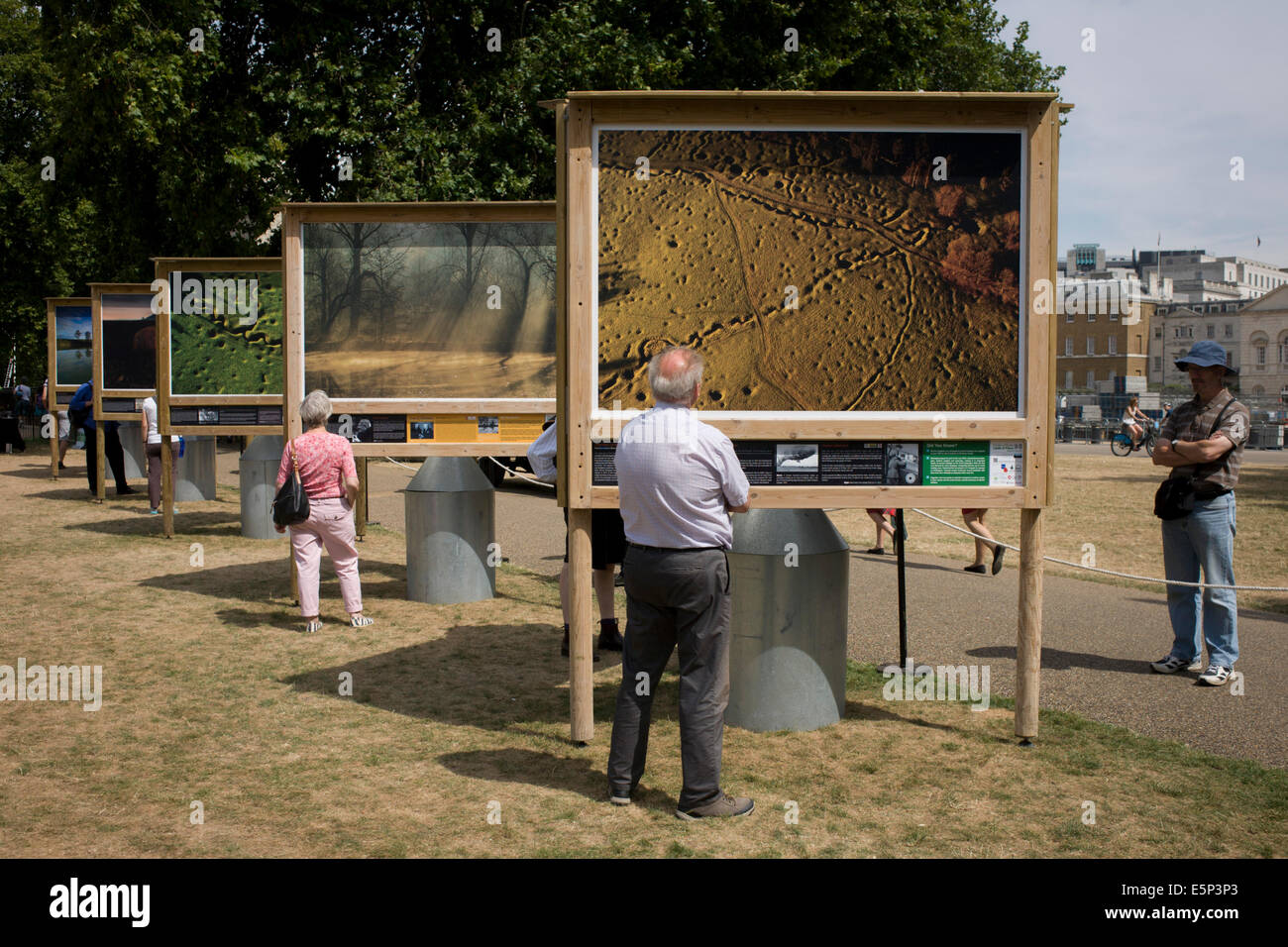 London, UK. 4th Aug, 2014. Marking the centenary of the the beginning of the First World War (WW1) in 1914, visitors to the Heritage Lottery funded, Fields of Battle Lands of Peace Street Gallery in St James's Park, central London, an outdoor exhibition of photography by Michael St Maur Sheil's 7-year project recording the landscapes of battefields along the Western front. Aerial views of Beaumont Hamel trenches include scarring in the land by shell holes. Across the world, remembrance ceremonies for this historic conflict that affected world nations. Credit:  RichardBaker/Alamy Live News Stock Photo