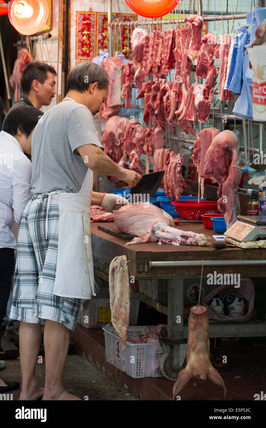 Hong Kong butcher cutting meat at a Gage street market Stock Photo Alamy