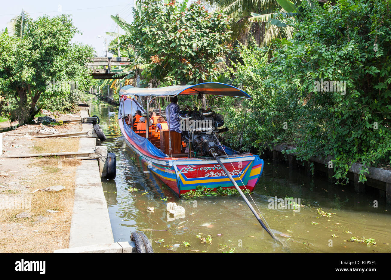 A Long-Tail Boat cruising through Bangkok's Klongs, Bangkok, Thailand Stock Photo