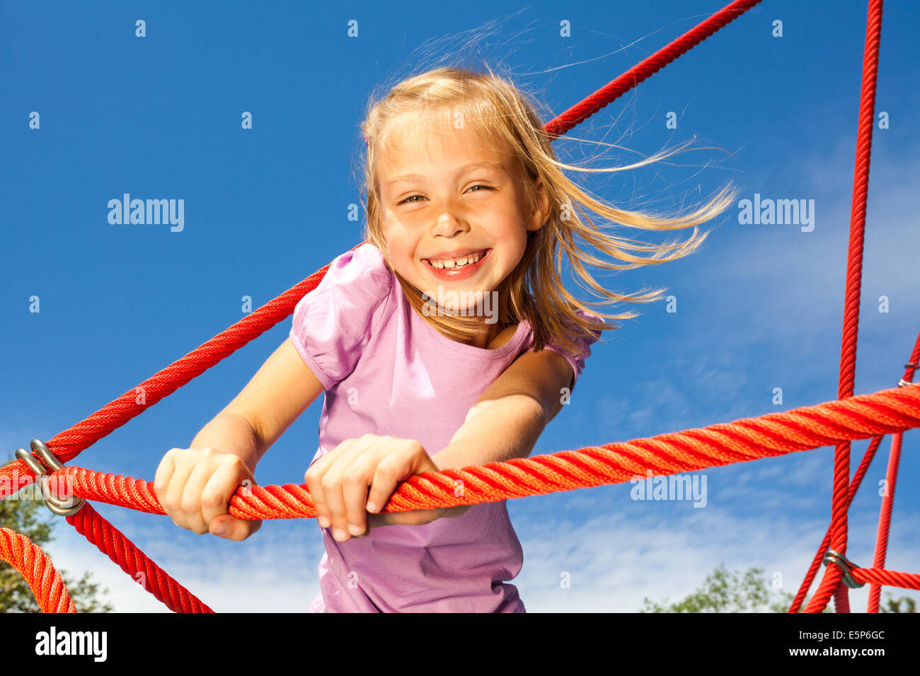 Girl Standing With Rope Laughing girl holds rope and stands on it in park Stock Photo - Alamy