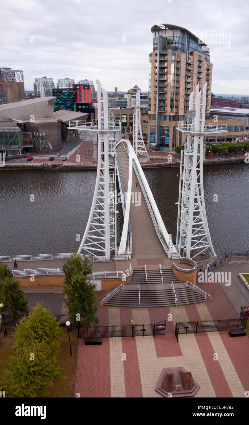 Millennium Bridge at Salford Quays, Manchester, with the Lowry Theatre and apartments and office blocks in the background. Stock Photo