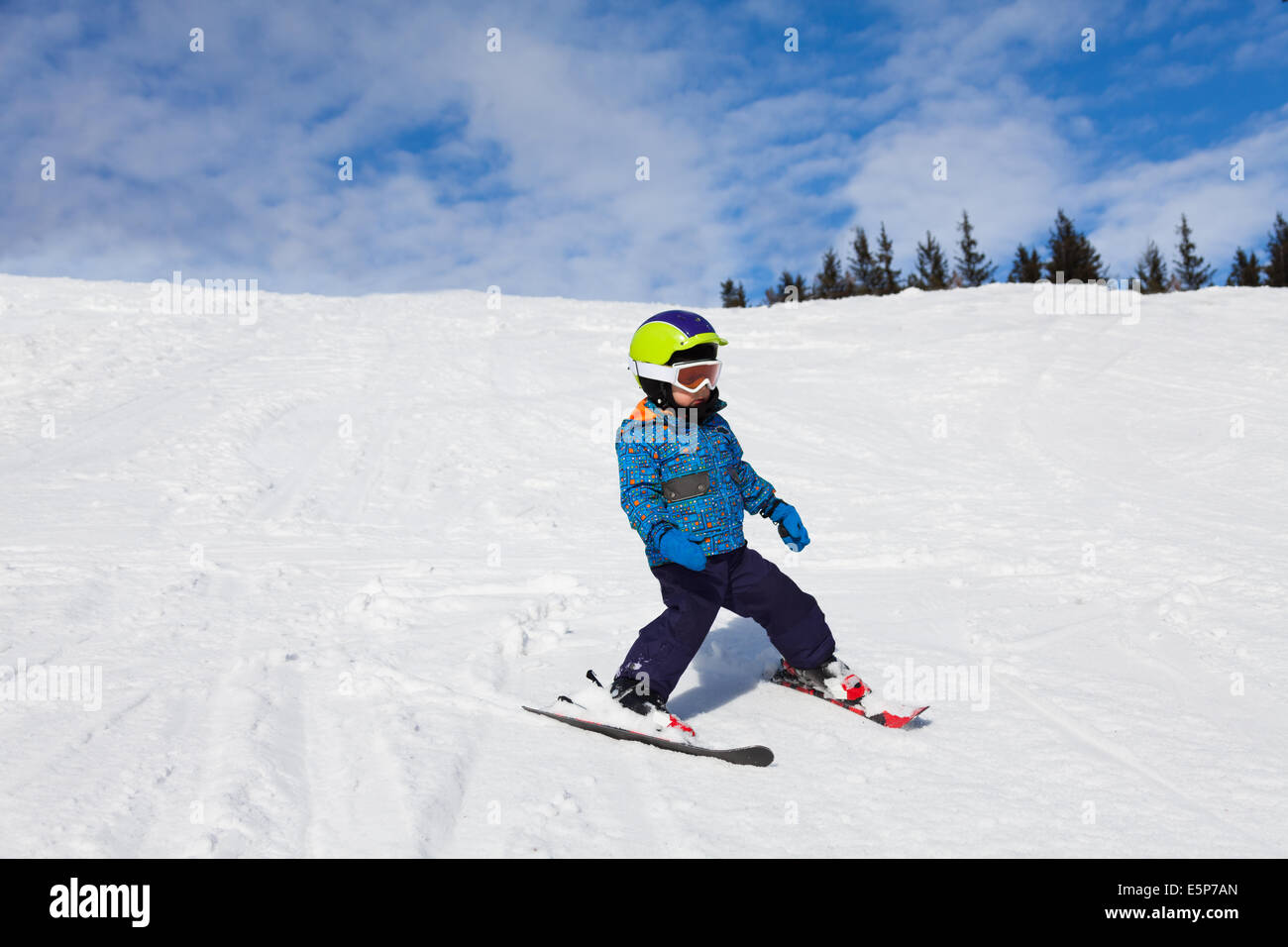Boy in ski mask skiing on snow downhill Stock Photo - Alamy