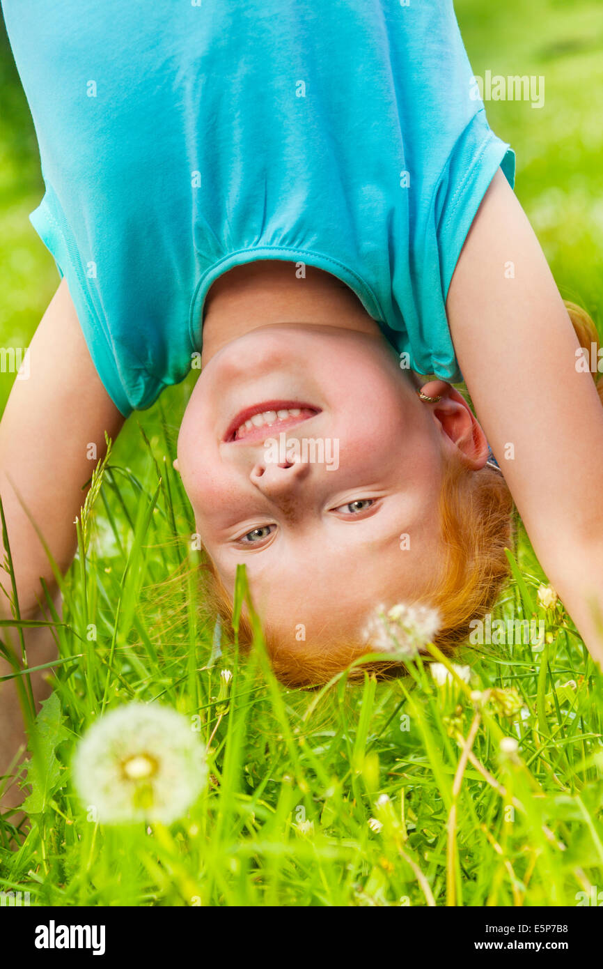 Little girl stands on her hands Stock Photo - Alamy