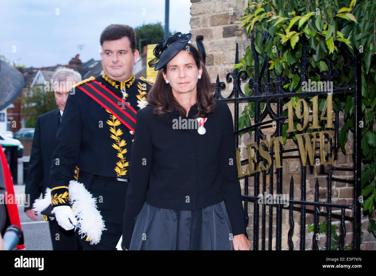 Twickenham, London UK, Monday August 4, 2014. Centre, wearing black, Her Serene Highness Princess Marie-Therese von Hohenberg (great-granddaughter of Archduke Franz Ferdinand of Austria–Hungary, whose assassination in June 1914 lead directly to World War 1, The Great War of 1914/1918) as she enters Radnor Gardens in Twickenham to take part in a service to mark the 100th anniversary of Great Britain's entry into the war, on Monday August 4, 2014. Left, wearing uniform, is her husband, Mr. Anthony Bailey OBE GCSS. Credit:  David Gee/Alamy Live News Stock Photo