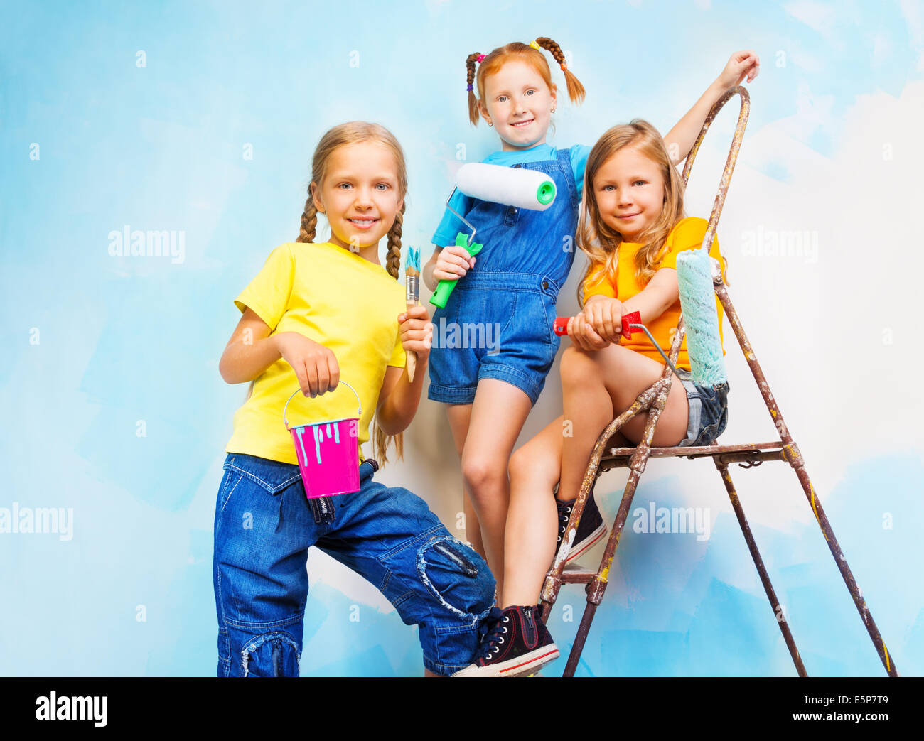 Three Girls Against The Background Of Wall Stock Photo Alamy