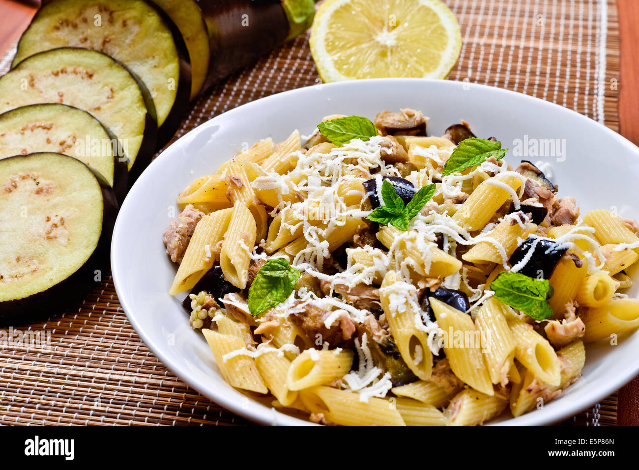 Pasta with eggplant, tuna, mint and ricotta salata. Recipe of Italian cuisine Stock Photo