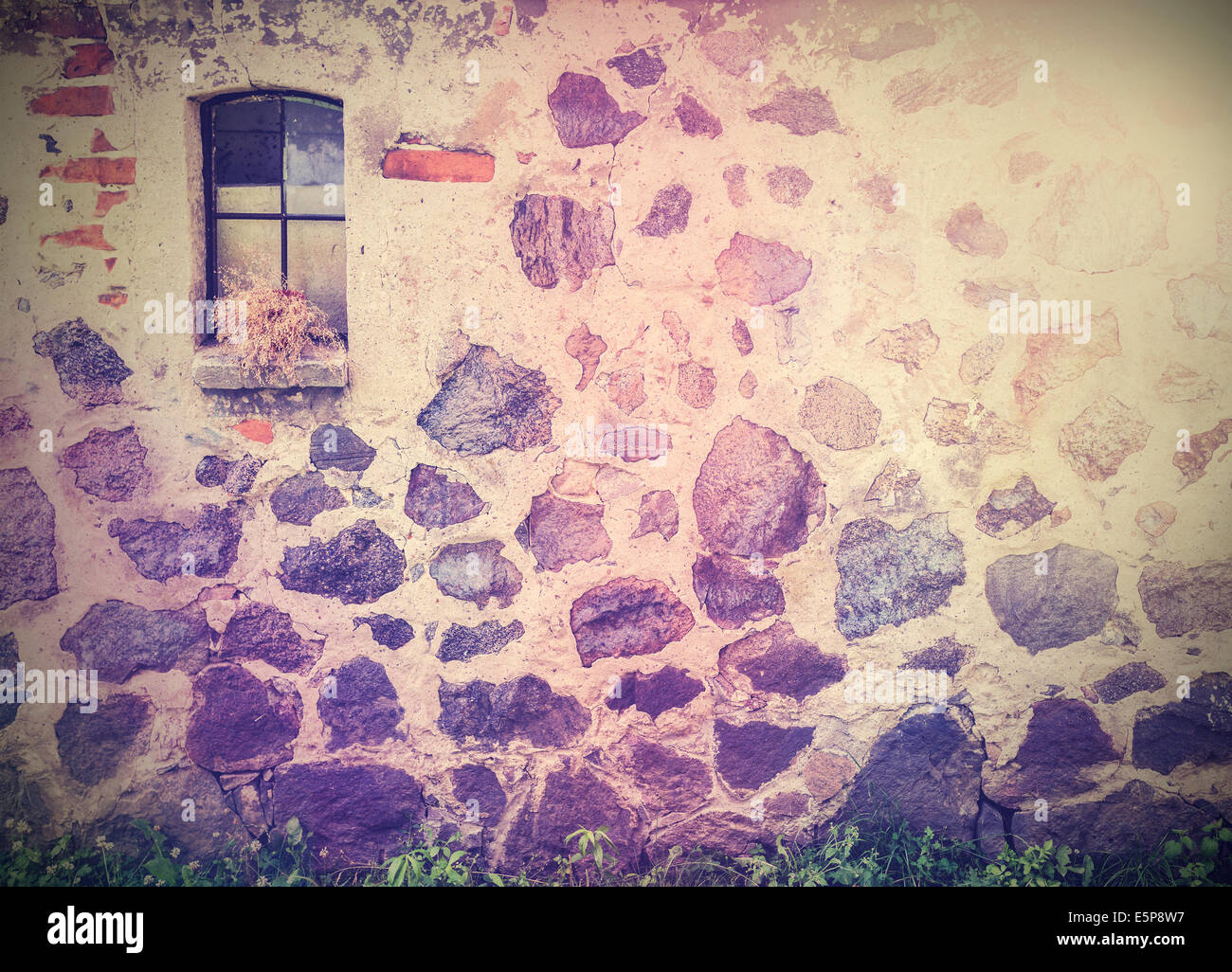 Vintage retro picture of stone wall with window. Stock Photo