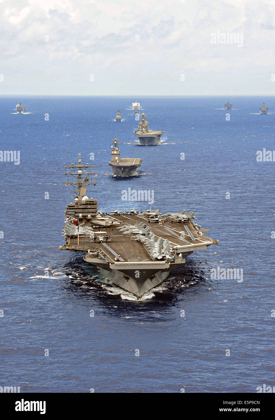 The US Navy Nimitz class aircraft carrier USS Ronald Reagan leads a close formation of 42 ships and submarines from 15 nations during Rim of the Pacific Exercise July 25, 2014 off the coast of Hawaii. Stock Photo
