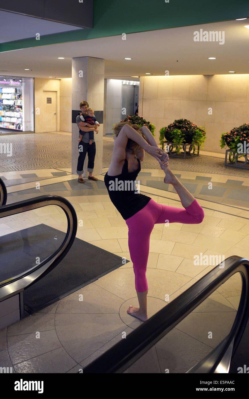 woman stretches san francisco shopping mall Stock Photo