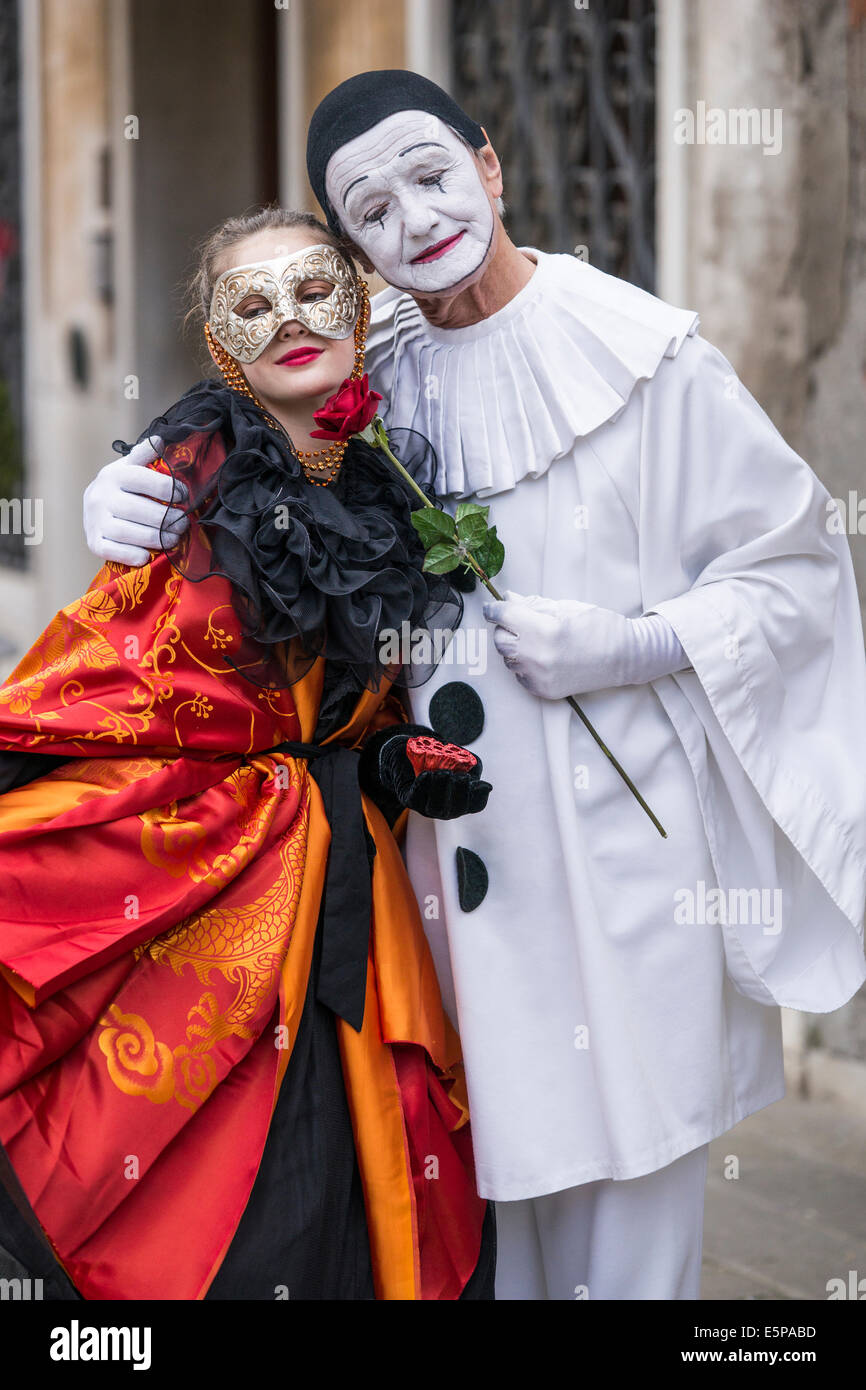 Mature Commedia dell'arte Pierrot courts young Spanish Lady in San Zaccaria Square during Carnival in Venice. Stock Photo