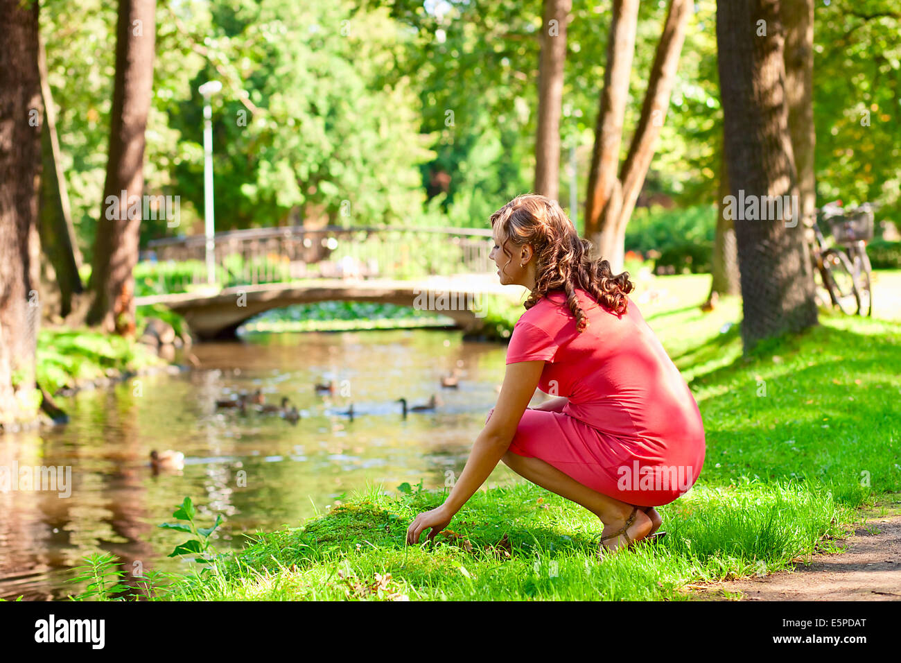The young pregnant woman on walk in park Stock Photo - Alamy