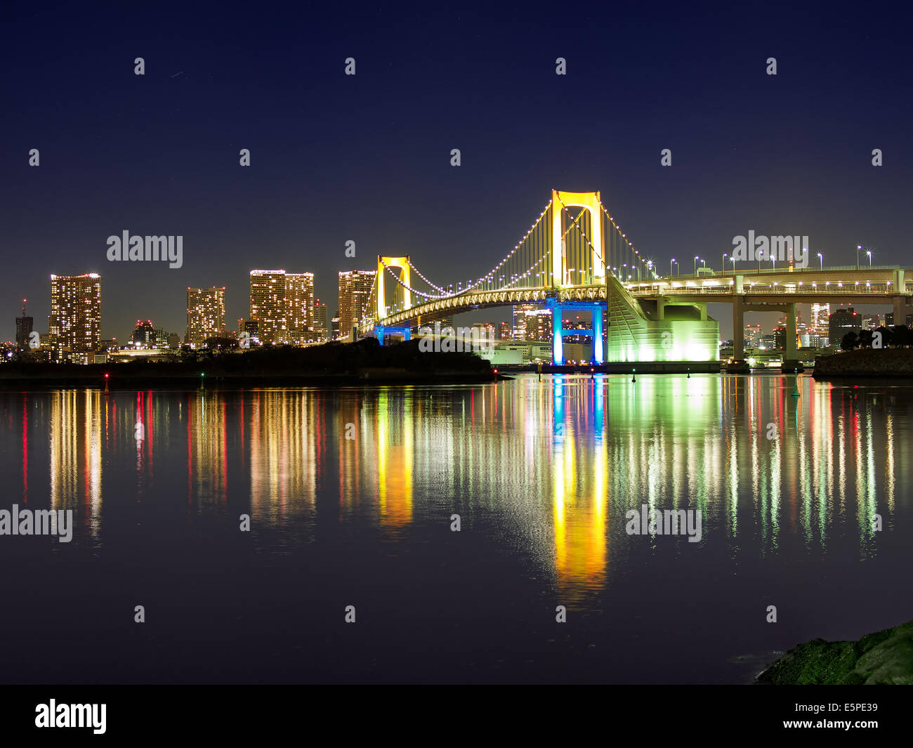 Rainbow Bridge at Night from Odaiba Park, Tokyo, Japan Stock Photo
