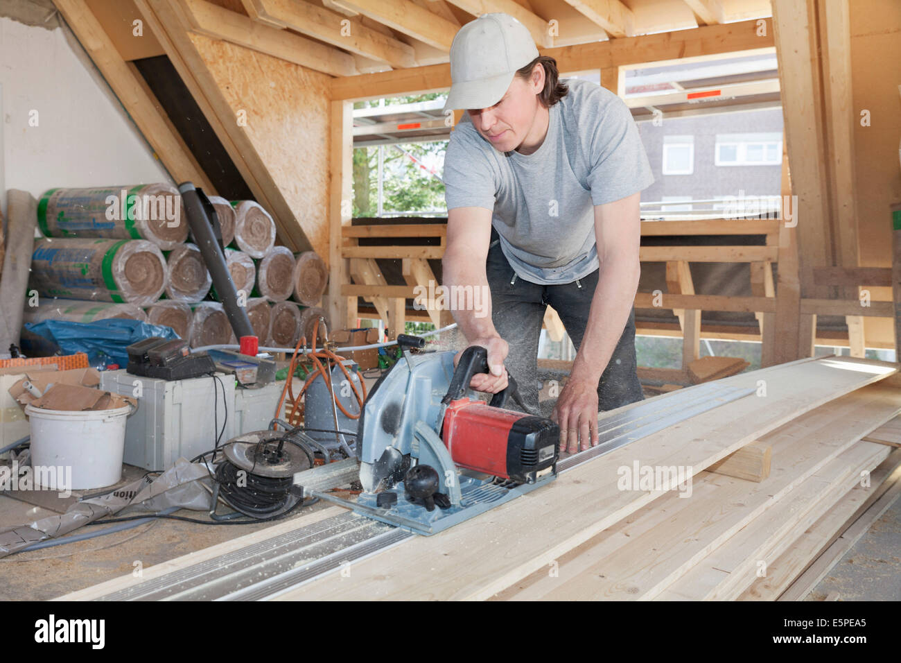 Carpenter working with a saw, roof truss extension Stock Photo