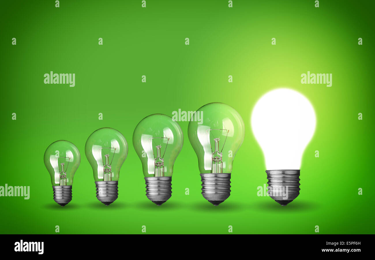 Row of light bulbs.Idea concept on green background. Stock Photo