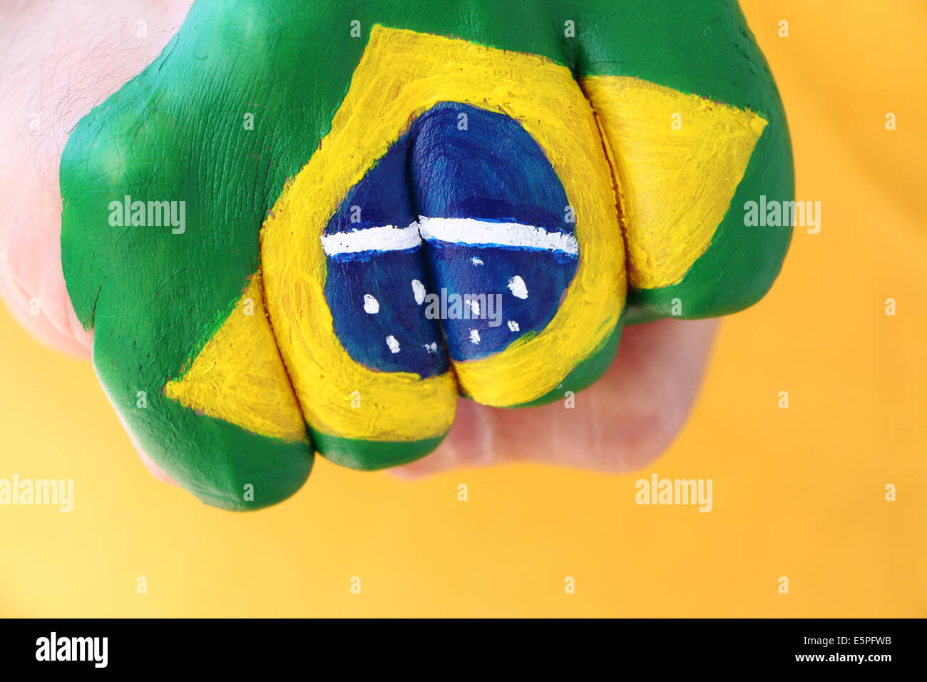 Brazilian flag on man's fist Stock Photo