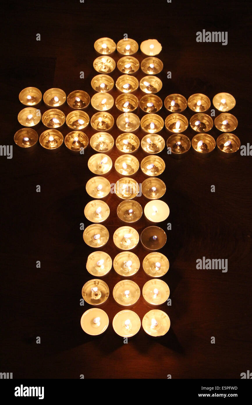Cross made of candles Stock Photo