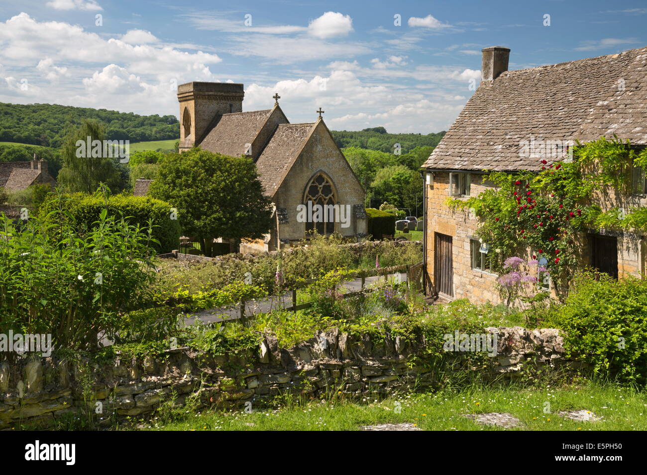 St. Barnabas Church and rose covered Cotswold cottage, Snowshill, Cotswolds, Gloucestershire, England, United Kingdom, Europe Stock Photo