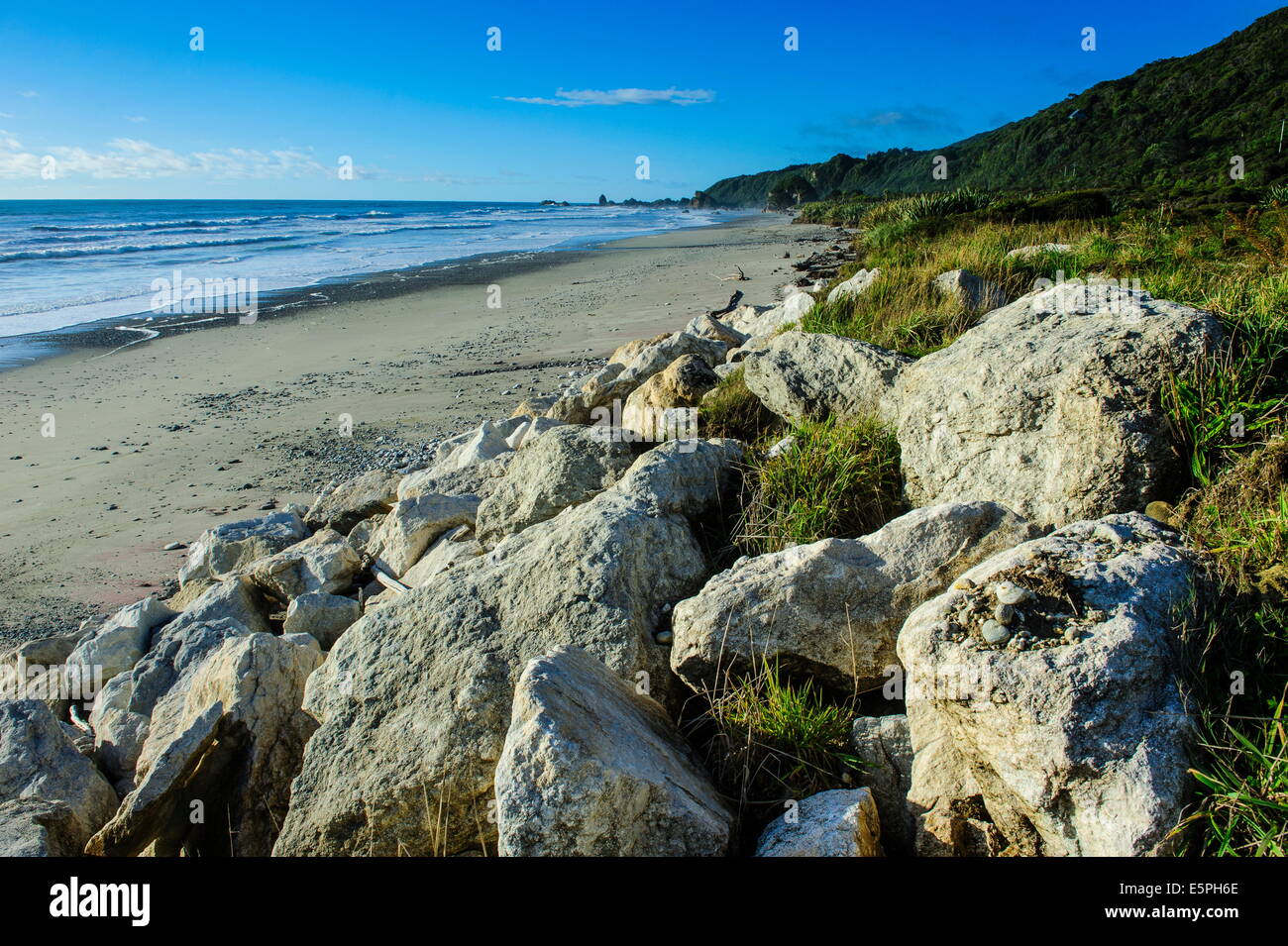 Rocks on a sandy beach on the west coast of South Island between Greymouth and Westport, West Coast, South Island, New Zealand Stock Photo