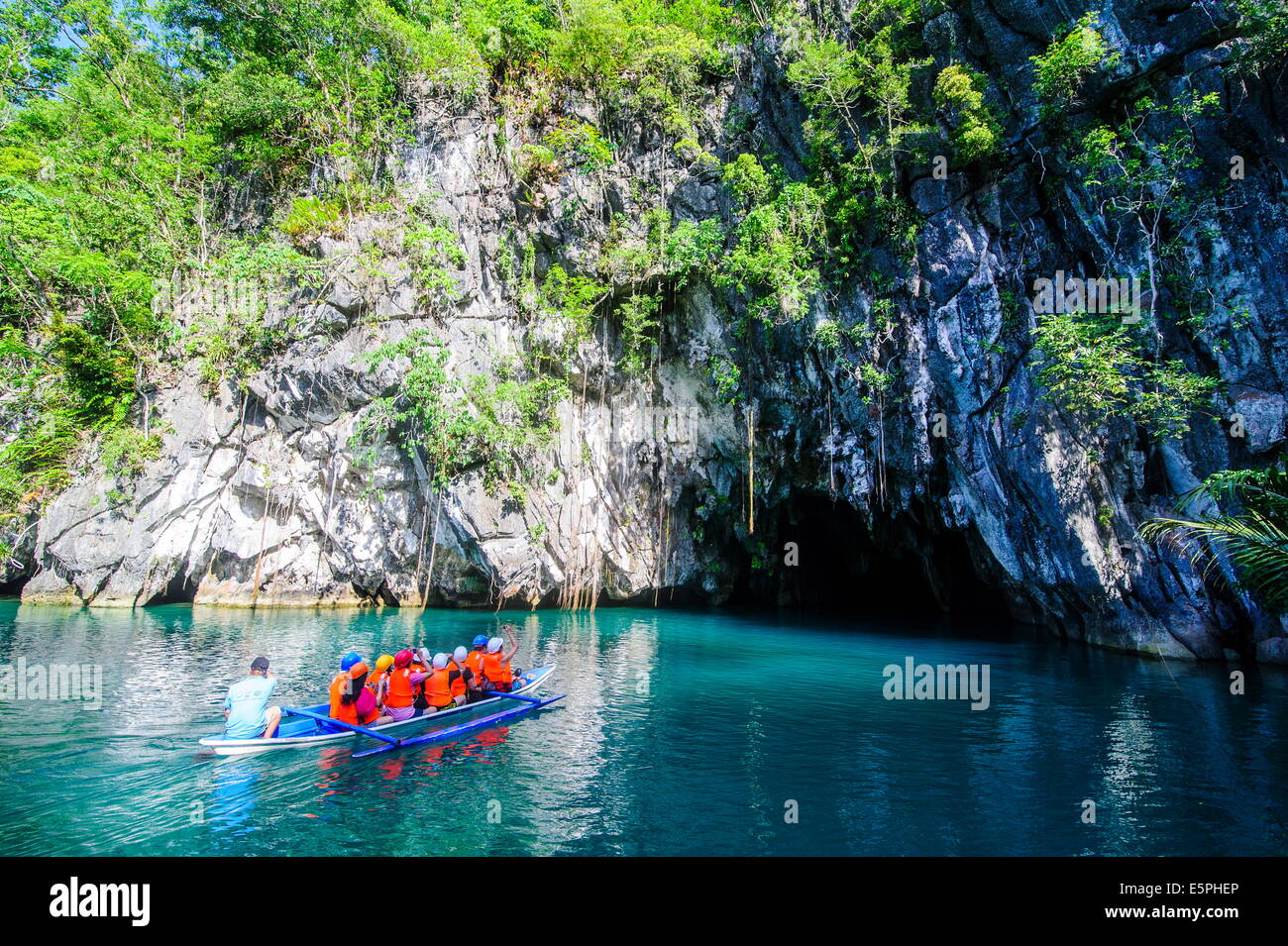 Tourists in a rowing boat entering the underground river, Puerto-Princesa River National Park, UNESCO Site, Philippines Stock Photo