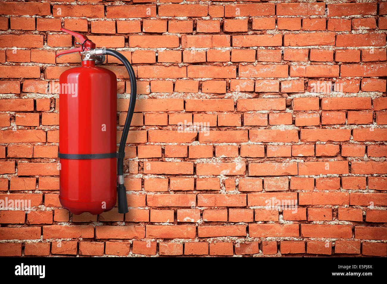 fire extinguisher on brick wall Stock Photo Alamy