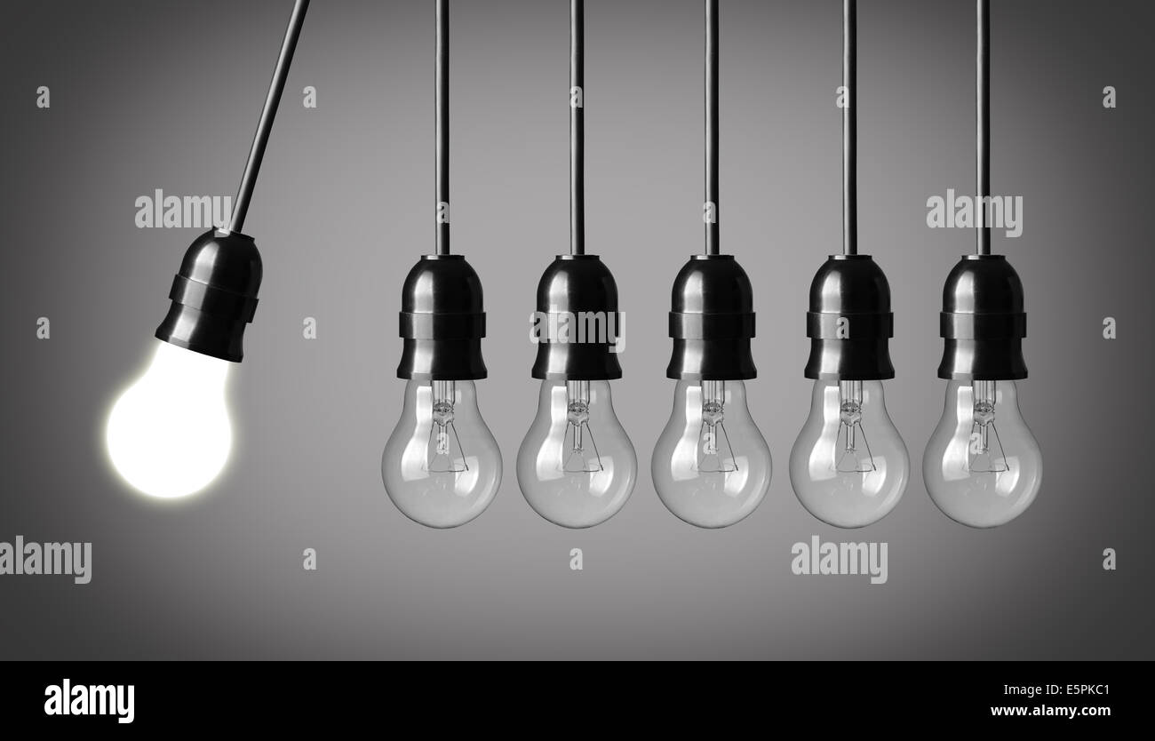 Perpetual motion with light bulbs. Idea concept on gray background Stock Photo