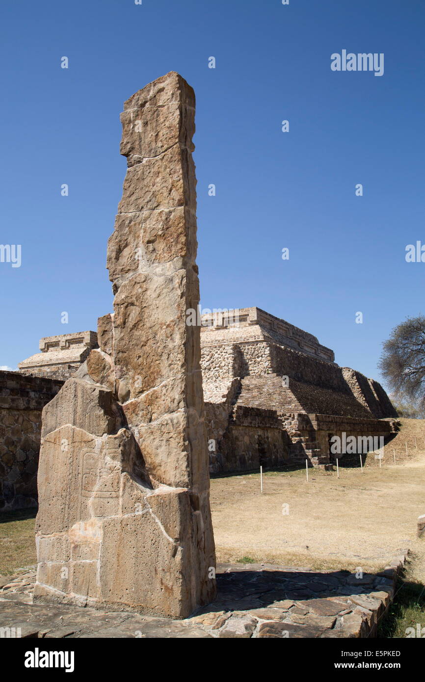Stela 18 dating from 100 BC with Building Group IV Ceremonial Complex in background, Monte Alban, UNESCO Site, Oaxaca, Mexico Stock Photo