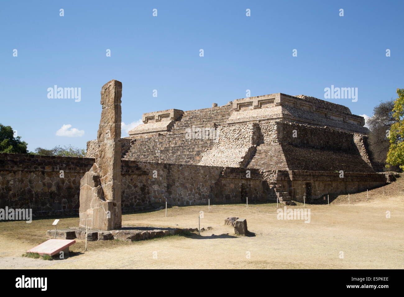 Stela 18 dating from 100 BC with Building Group IV Ceremonial Complex in background, Monte Alban, UNESCO Site, Oaxaca, Mexico Stock Photo