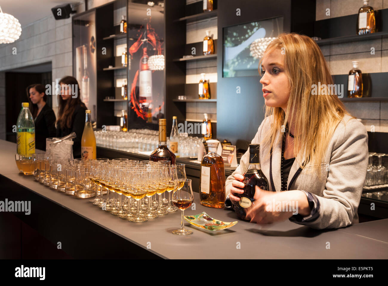 A Hennessy employee explains the different qualities of the Cognac in the tasting room. Stock Photo