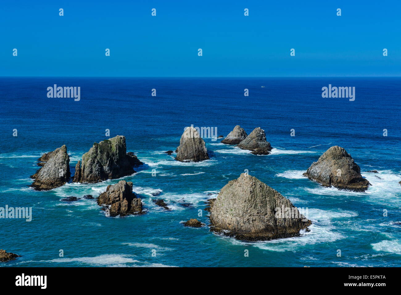 View from the Nugget Point Lighthouse in the turquoise waters with huge rocks, the Catlins, South Island, New Zealand, Pacific Stock Photo