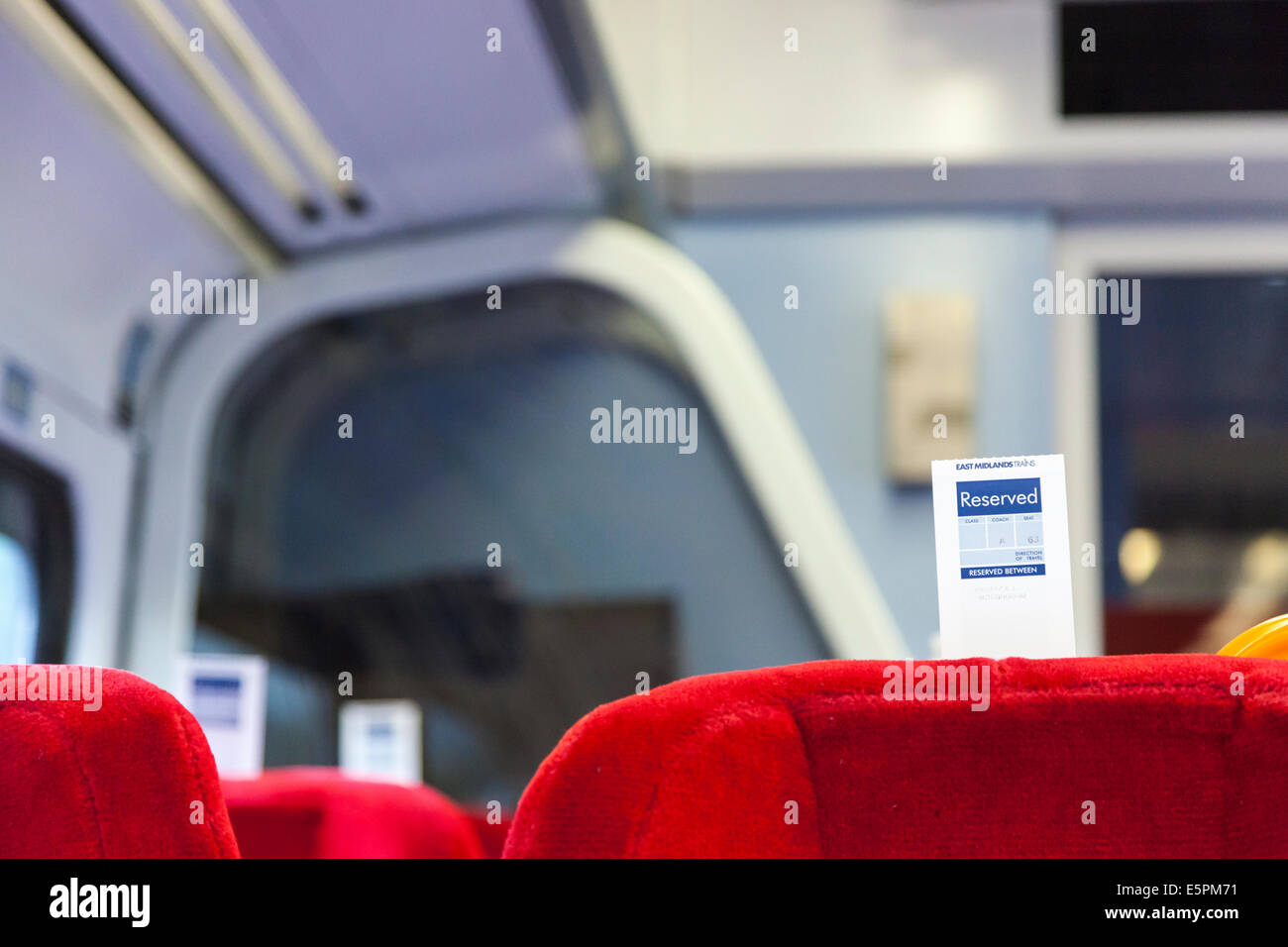 Train reservation ticket attached to the back of seating for a reserved seat on an East Midlands Trains train, England, UK Stock Photo