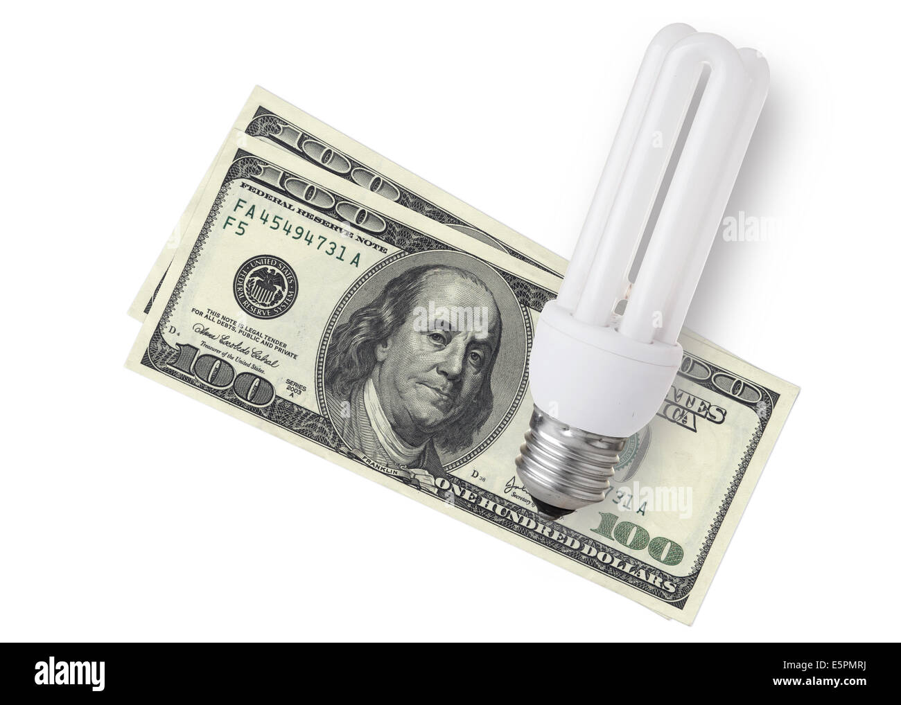 Enegy saver bulb over dollar bills on white background Stock Photo