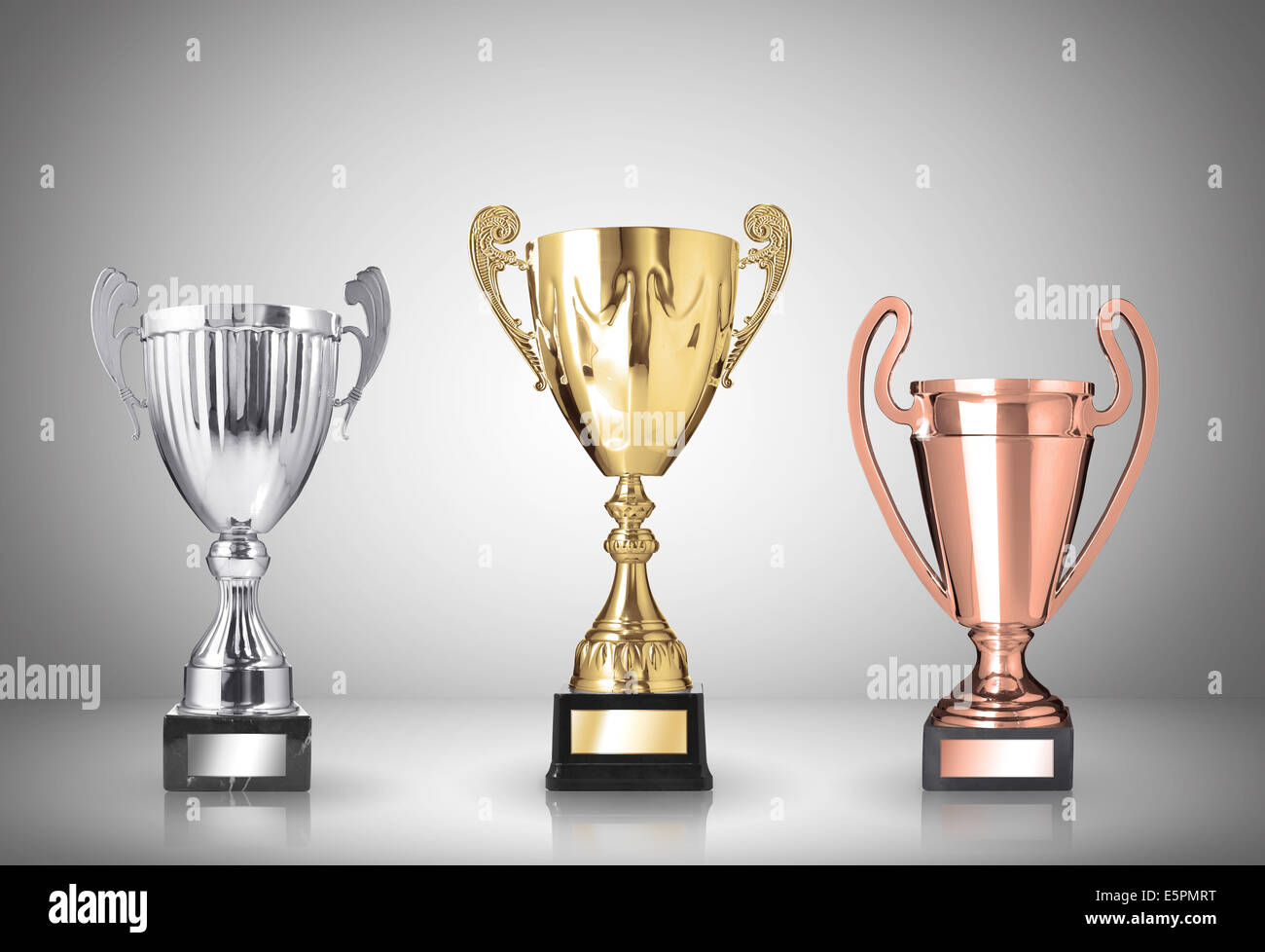 golden, silver and bronze trophies on gray background Stock Photo - Alamy