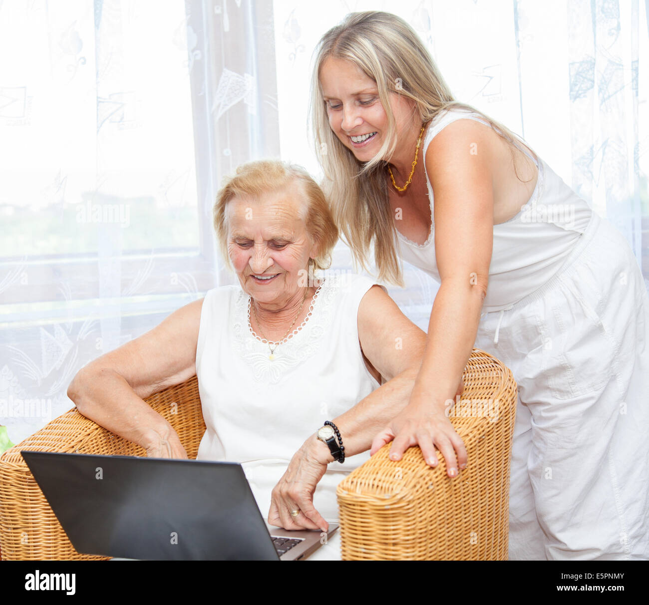 Helping out elderly with new technology Stock Photo