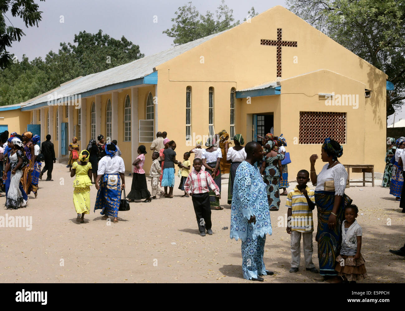 Faithful stand together after the sunday service in the catholic St. Timothy church in Maiduguri, Nigeria Stock Photo