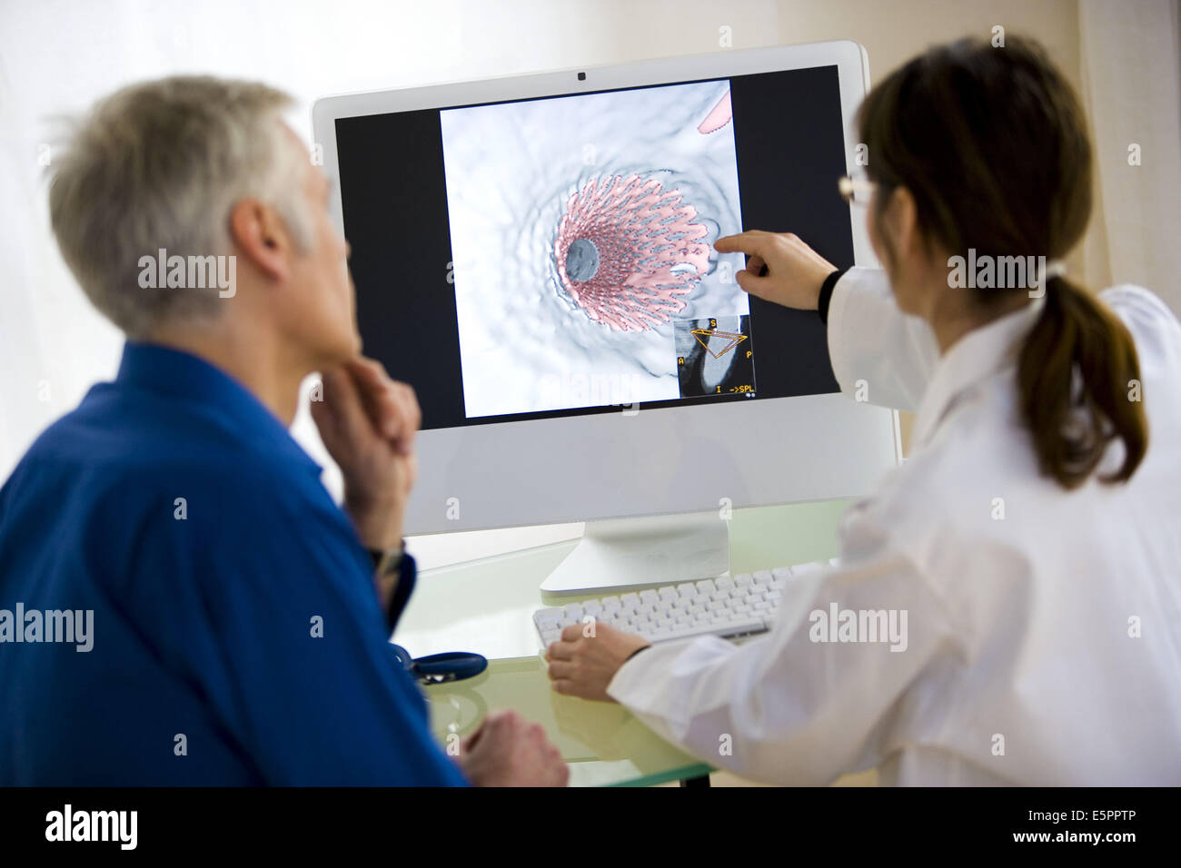 Doctor showing patient virtual endoscopy hires stock photography and