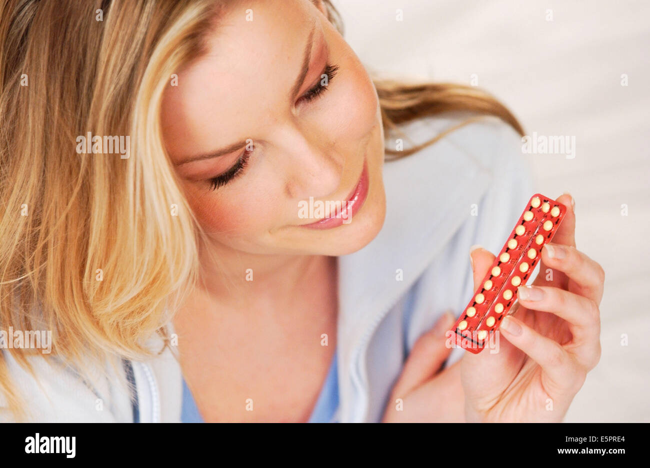 Woman taking contraceptive pill Stock Photo - Alamy