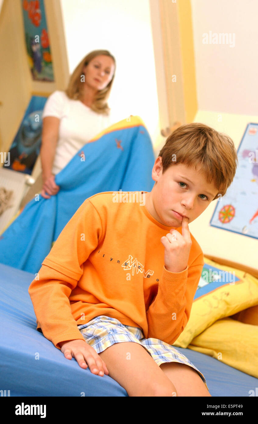 8 Year Old Boy In His Bedroom With His Mother Stock Photo