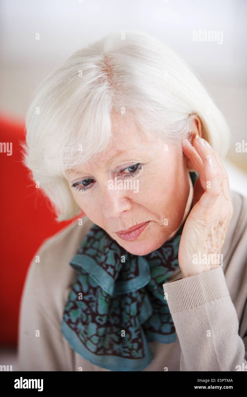 Elderly woman and hearing. Stock Photo