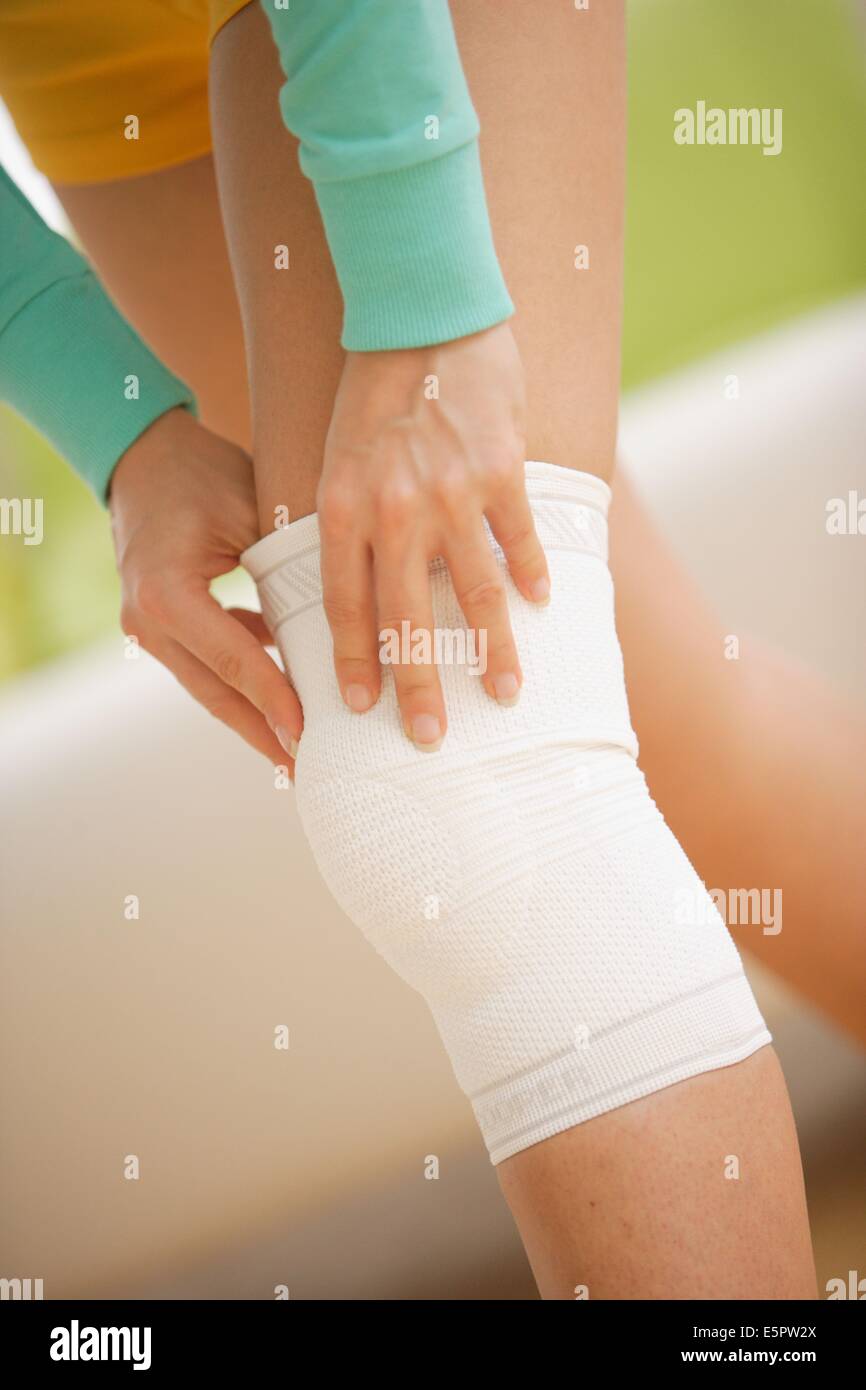 Woman wearing a knee support Stock Photo Alamy