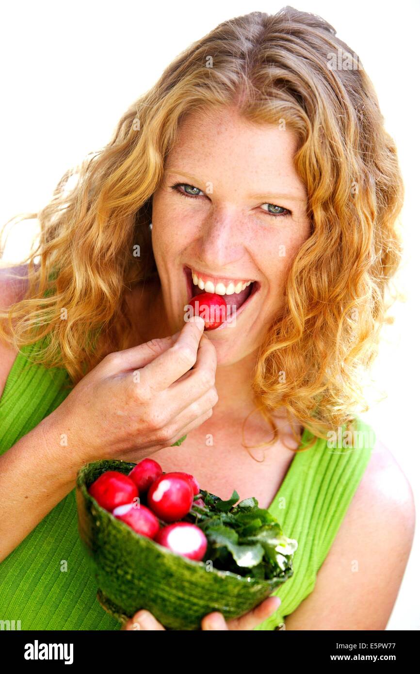 Woman eating radishes Stock Photo Alamy