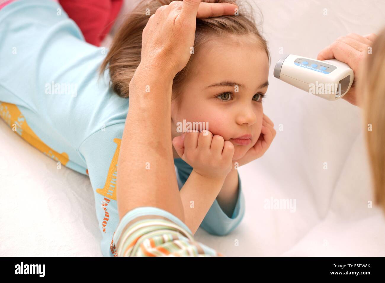 Digital instant infrared thermometer (thermoflash) being used to measure  the core body temperature of a 5 year old girl Stock Photo - Alamy