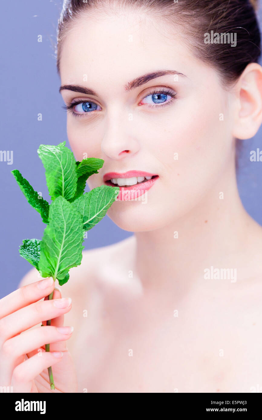 Woman smelling mint leaves (Mentha sp Stock Photo Alamy