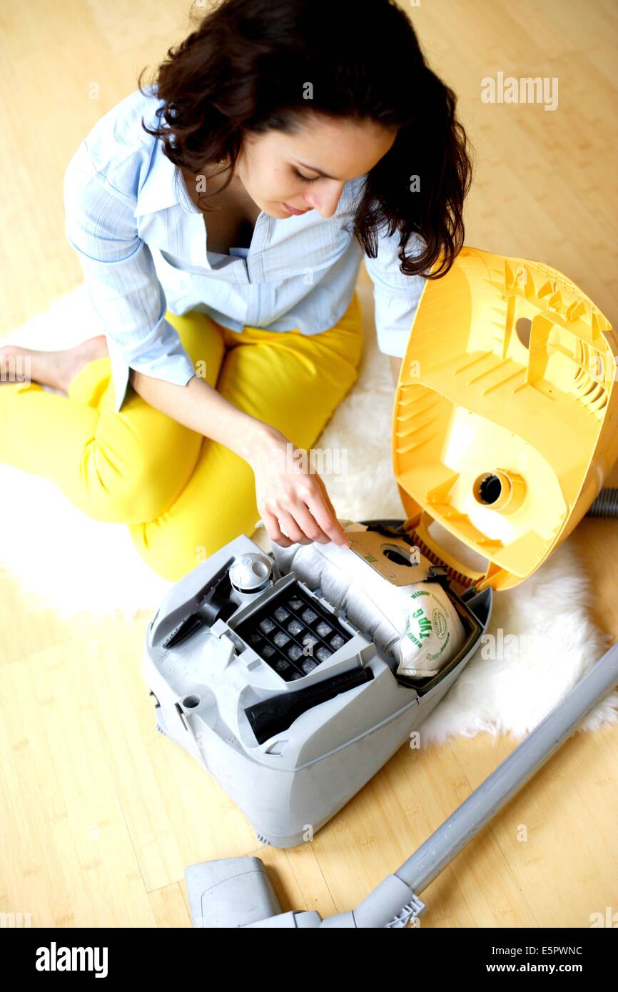Woman changing vacuum cleaner bag Stock Photo Alamy