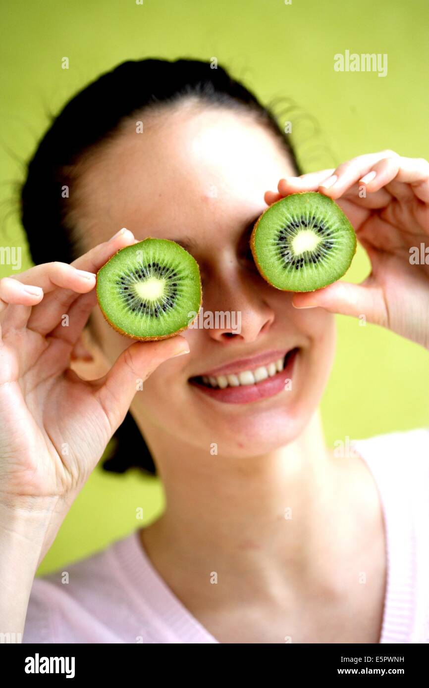Woman eating kiwi fruit Stock Photo Alamy